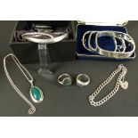 A small collection of silver jewellery including a colourless paste set stiff hinged bangle,