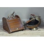 An Edwardian mahogany coal box with shovel and brass loop handle and a brass coal helmet with shovel