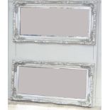 A pair of large rectangular wall mirrors, the silvered frames moulded with shells and leaves and