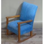 A child's rocking chair upholstered in blue fabric