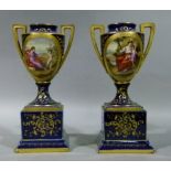 A pair of Vienna style two handled vases of pedestal urnular form each painted with oval reserve