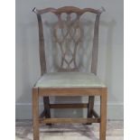A mahogany Chippendale style chair having a wavy top rail, pierced vase splat, upholstered seat on
