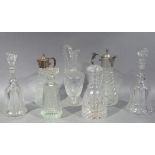 A pair of decanters, two moulded glass claret jugs, cut glass decanter of triangular shape, ewer and