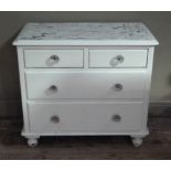 A Victorian white painted chest of two short and two long graduated drawers on turned feet, glass