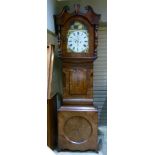 A late 19th century mahogany longcase clock having a broken swan neck pediment, painted arched