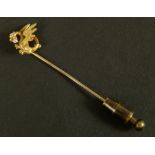 An early 20th century diamond set tie pin in 9ct gold, the dragon passant head claw set with a small