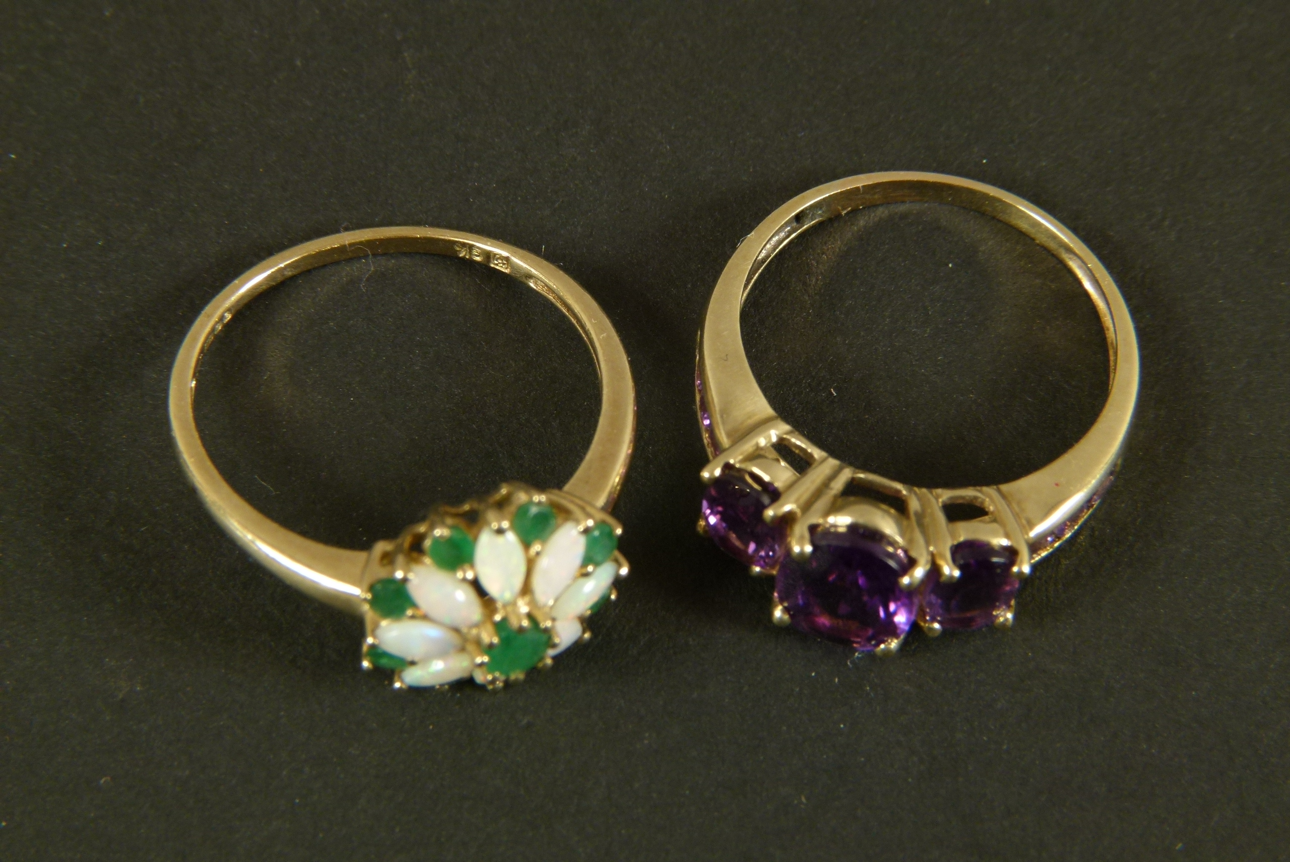 An amethyst dress ring, three graduated oval faceted stones claw set in line flanked by channel - Image 2 of 2
