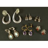 A small collection of silver earrings including a pair of loops each set with six small brilliant