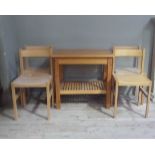 A two tier kitchen table together with a set of four kitchen chairs with concave backs and wooden