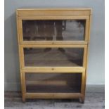 A light oak three section Globe Wernicke style book case