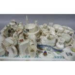 A large quantity of crested china ware including banjo fish, chair, scottie dog, range, vases etc