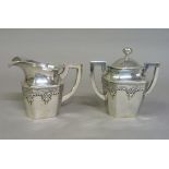 A Chinese silver coloured metal lidded two handled sugar bowl and matching cream jug, each piece