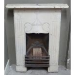 A late 19th century cream painted cast iron bedroom fireplace, cast with stylised fruiting stems