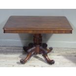 A Victorian mahogany tilt top breakfast table on a bold tulip carved pedestal on four leaf carved
