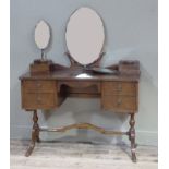 A mahogany finished dressing table with mirror on refectory base