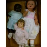 Three vintage dolls, one in composition, sleeping eyes and voice box, another composition with