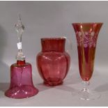 A Victorian cranberry glass jug with reeded clear loop handle, 18.5cm high; a cranberry glass
