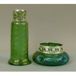 A Loetz style iridescent green glass vase of tapered cylindrical form with spreading foot, moulded