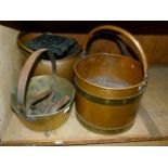 A copper coal scuttle, cast iron trivet, two brass preserve pans and two flat irons, and a copper