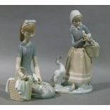 A Lladro porcelain figure of a young girl kneeling, basket and dove feeding from her left hand, 21cm