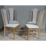 A set of four beech dining chairs with upholstered splats and seats