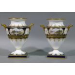 A pair of Wedgwood two handled vases of urn shape, each painted with reserves of abbey ruins