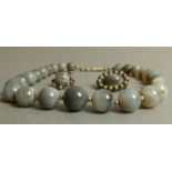 A Victorian necklace, brooch and one earring all set with grey banded agate cabochons and
