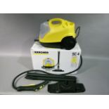 A Karcher steam cleaner with instruction book