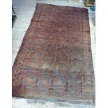 A large Bokhara style carpet having four rows of ten elephant foot medallions within a border of