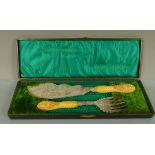 A pair of Victorian silver plated fish servers, with foliate engraved handles, the ivory handles