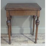 An oak card table rectangular with twist top lined in baise on rounded legs with cup and cover style
