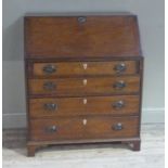 A mahogany bureau having a fall front with fitted interior over four graduated drawers with shaped