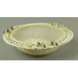 A Belleek four strand blackberry basket, circular with green accents to leaves and upper rim, pink