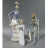 A Lladro figure of a young girl playing a mandolin, 20cm high; a Lladro figure of a young boy