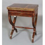 AN EMPIRE DESIGN MAHOGANY AND BRASS-INLAID CARD TABLE, having a rectangular fold-over top lined in