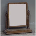 A Victorian oak toilet mirror having a rectangular glass on ring turned uprights and platform base
