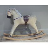 A corduroy rocking horse with leather harness and seat, 106cm wide