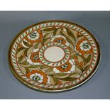 A Royal Ducal ware circular charger by Charlotte Rhead, slip trail decorated with stylised orange