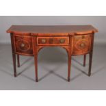 AN Edward VII mahogany semi-bow front sideboard, banded and crossbanded in rosewood, having a drawer