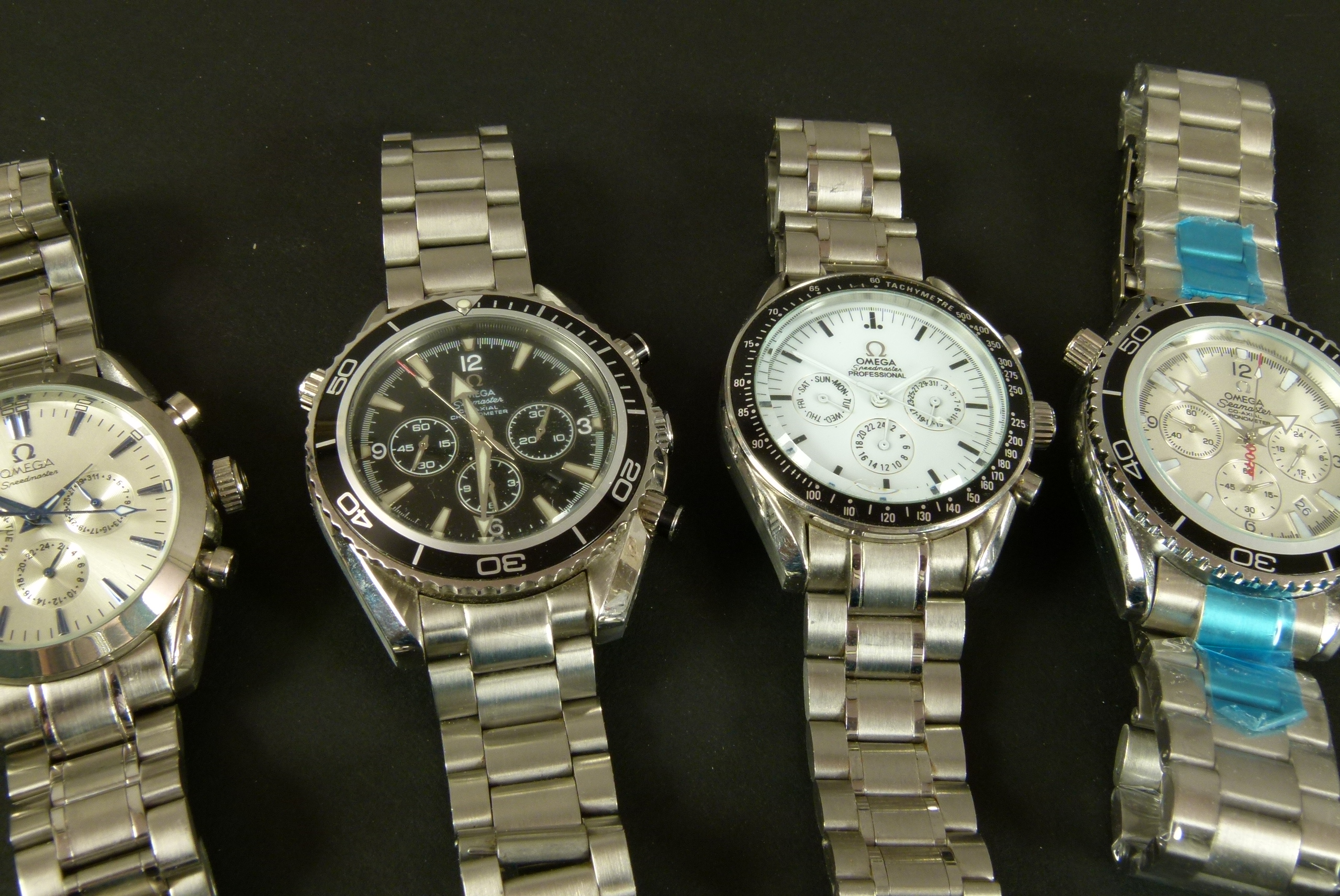 Four fake Omega gentleman's wristwatches all in white base metal and bracelets - Image 2 of 2