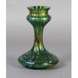 A Loetz style iridescent green glass vase with compressed base, waisted neck and bulbous top with