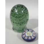 A Victorian green glass dump paperweight or doorstop, 15cm high; together with a Millefiori glass