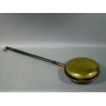 A 19th century brass and copper warming pan on turned fruitwood handle