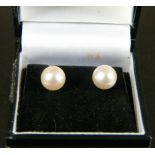 A pair of 8mm cultured pearl ear studs on 9ct gold post and scroll fittings