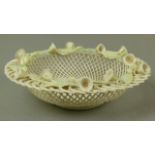 A Belleek four strand convolvulus basket, circular with green accents to leaves, brown to stamens,