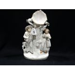 A Staffordshire Pottery Figural Pocket Watch Holder Group, 14" High