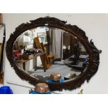 A Carved Oak Framed Oval Wall Mirror