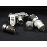 A Leica Early 1960s 35mm Camera, Together With Three Further Lenses & A Light Meter