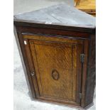 An Antique Oak Single Door Hanging Corner Cupboard With Shell Inlay