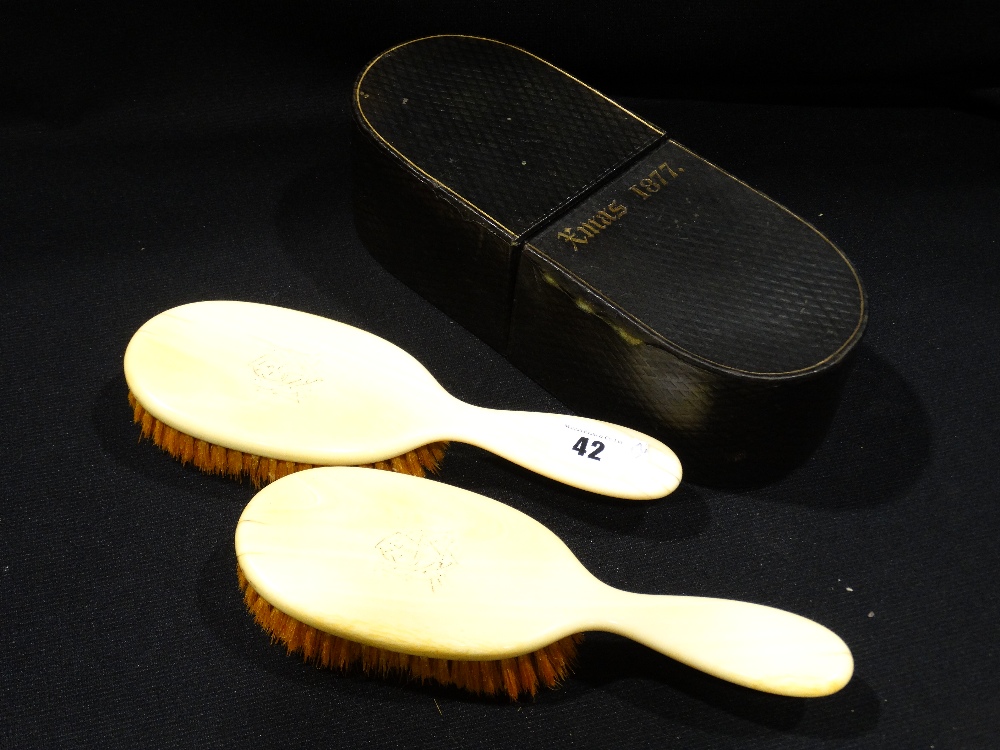 A Boxed Pair Of Antique Ivory Backed Clothes Brushes, The Box Dated Christmas 1877